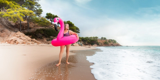 Woman on Beach Flamingo Floaty