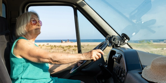 older lady driving camper van