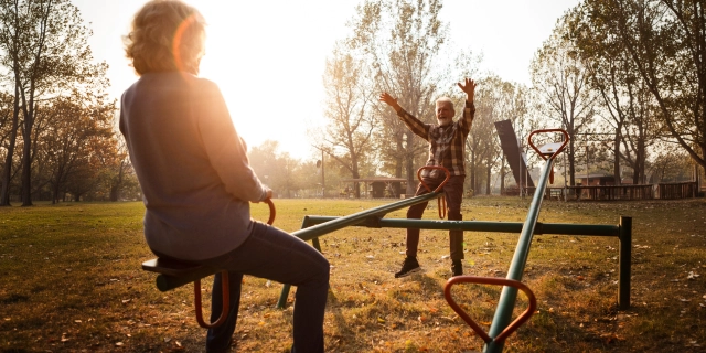 mature couple on see-saw