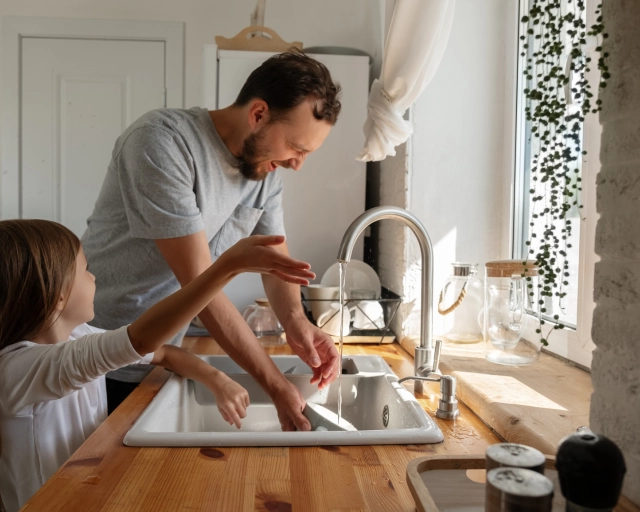 father and daughter doing dishes