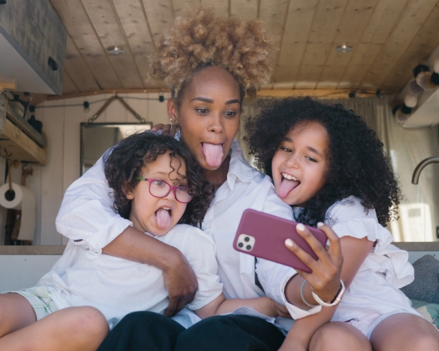 mom and daughters taking a selfie