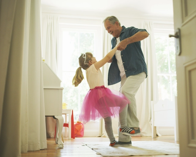 grandfather and granddaughter dancing