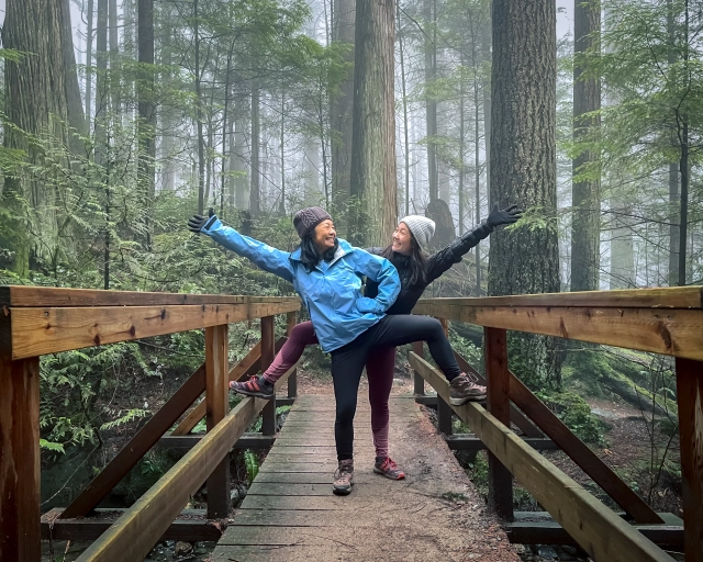 mom and daughter pose in forest